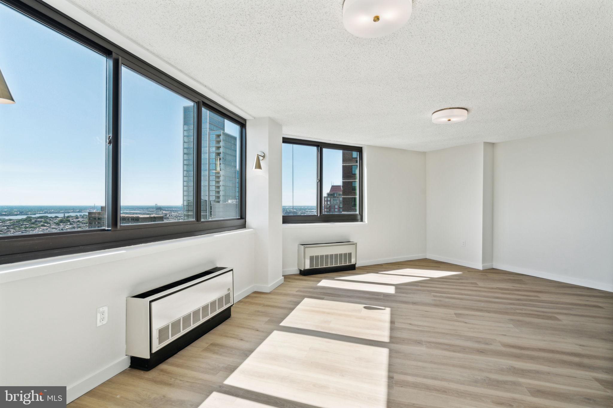 a living room with stainless steel appliances kitchen island granite countertop a refrigerator and a stove