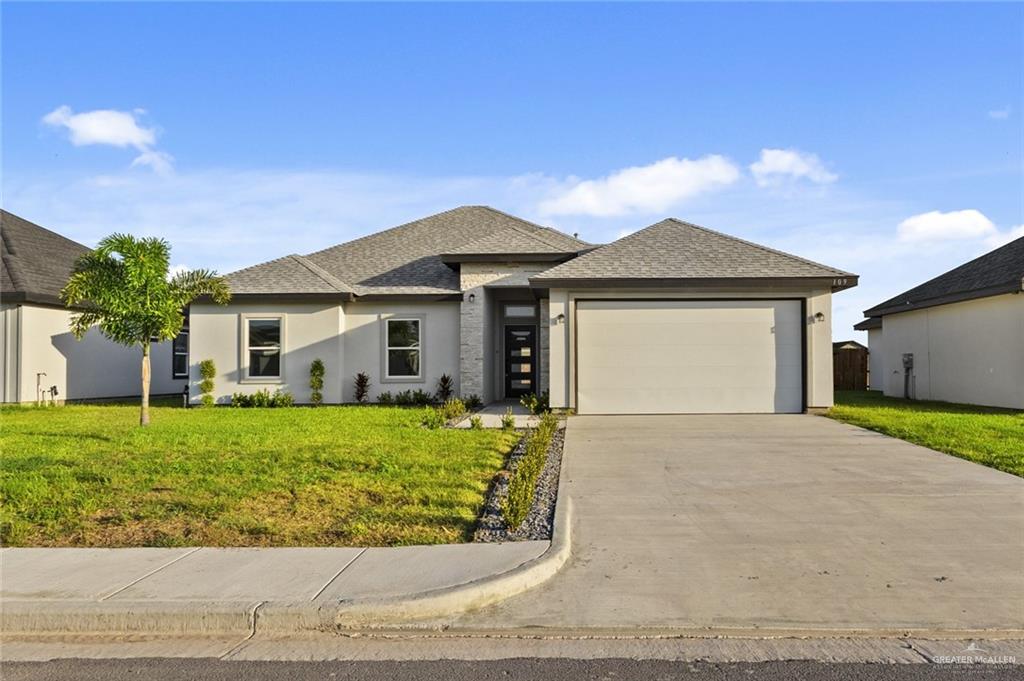 a front view of a house with a garden