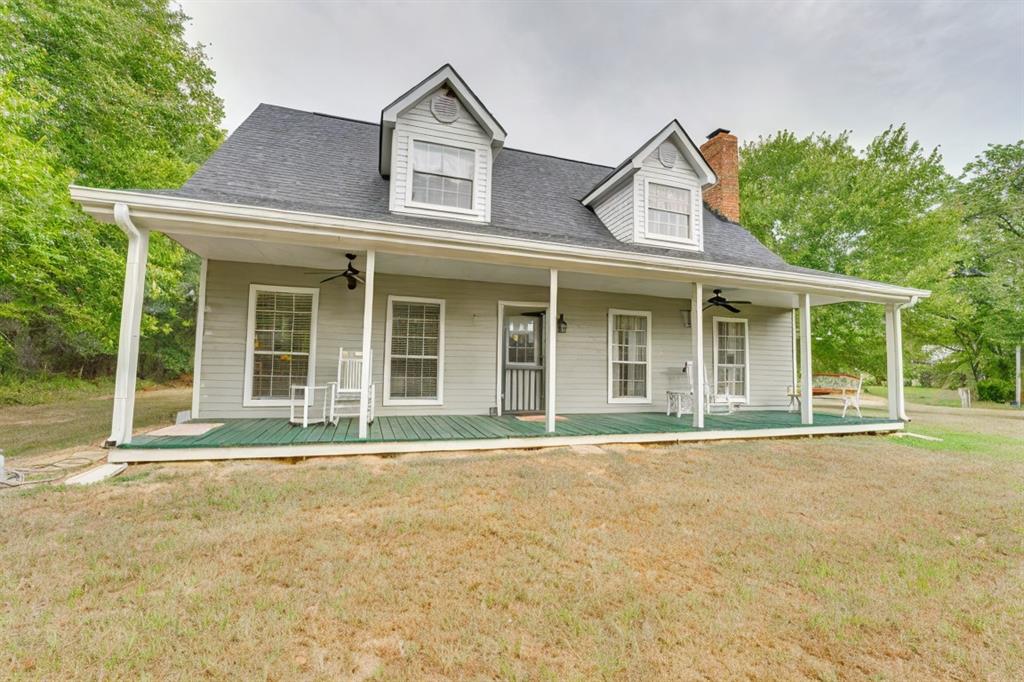 front view of a brick house with a yard