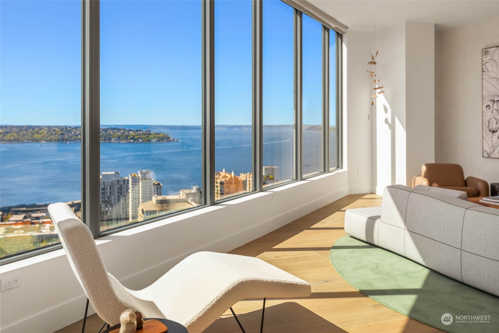 a living room with a large window and furniture