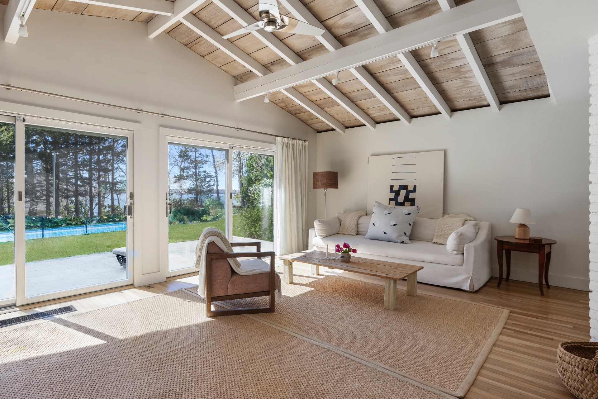 a living room with furniture and a floor to ceiling window