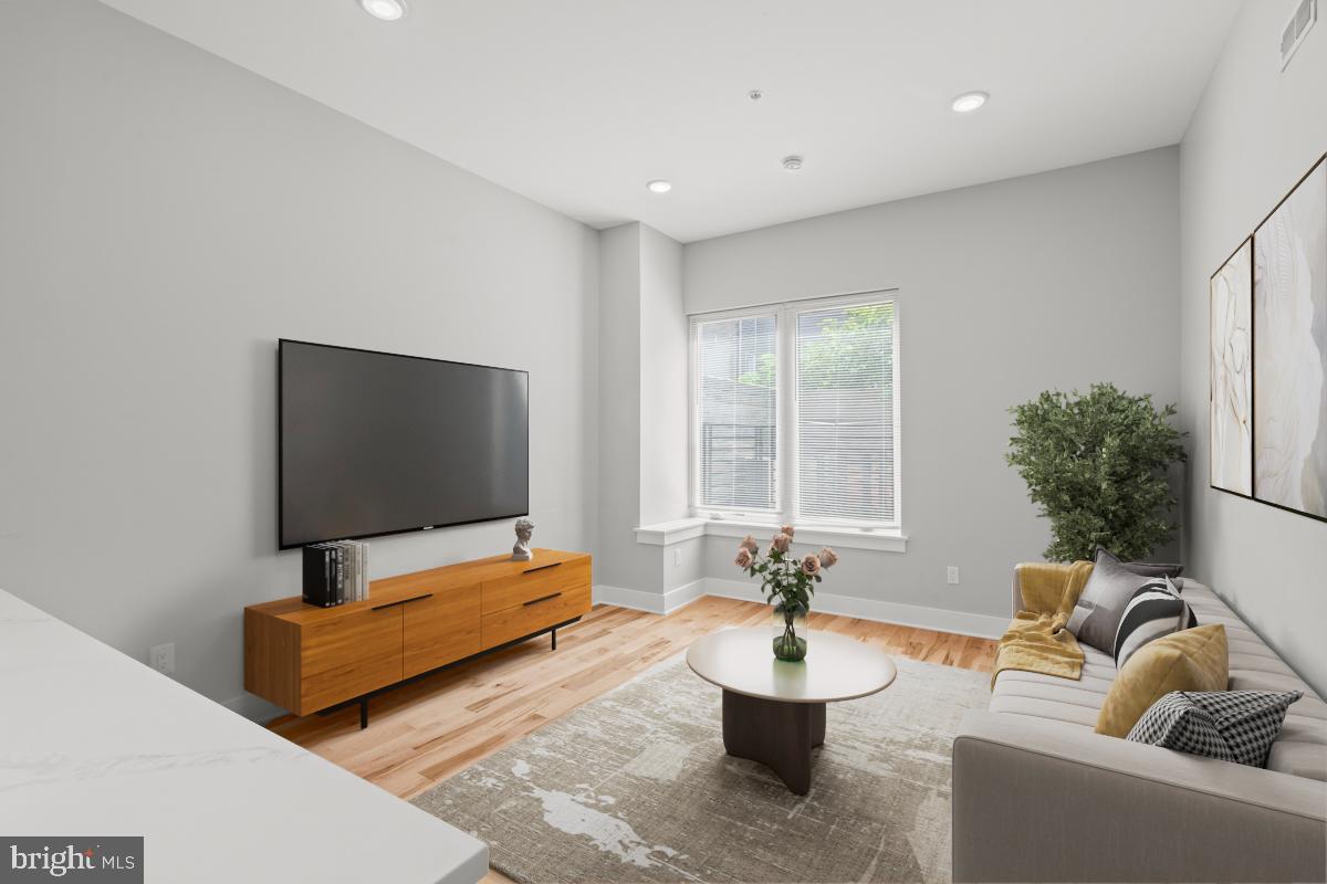 Living Room - Bright, spacious with large windows.