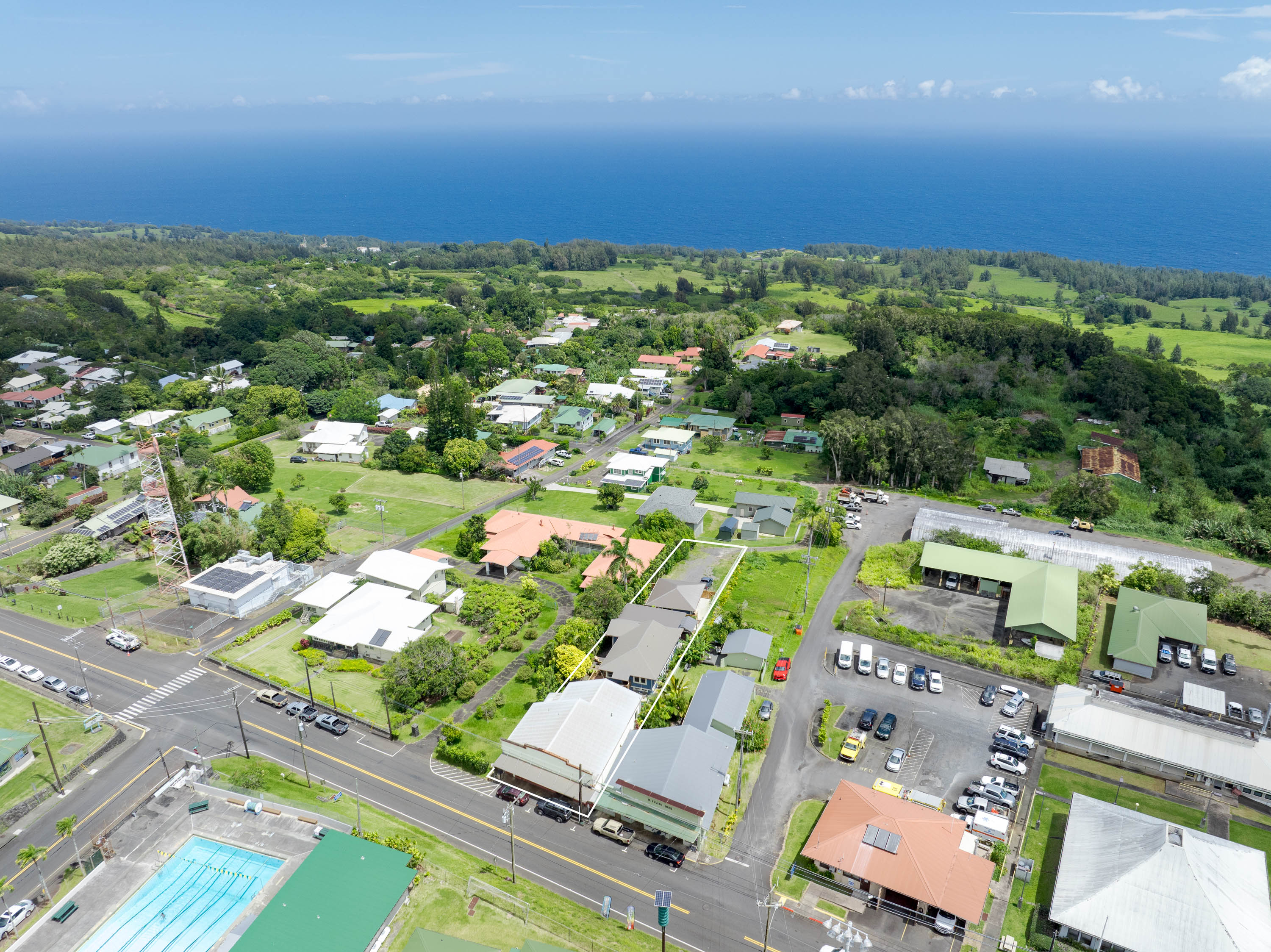 an aerial view of residential houses with outdoor space and street view