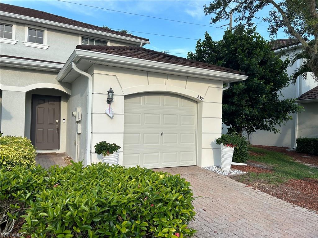 a front view of a house with a garage