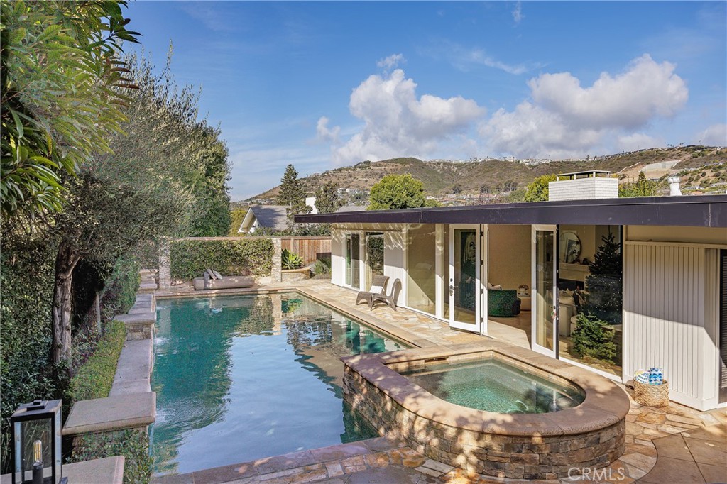 a view of a house with swimming pool and sitting area