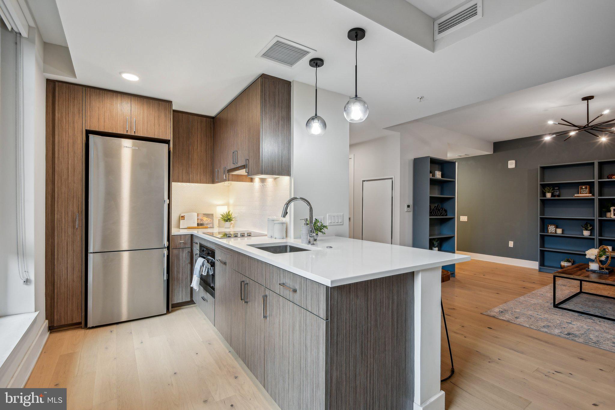 a kitchen with stainless steel appliances a refrigerator and a stove