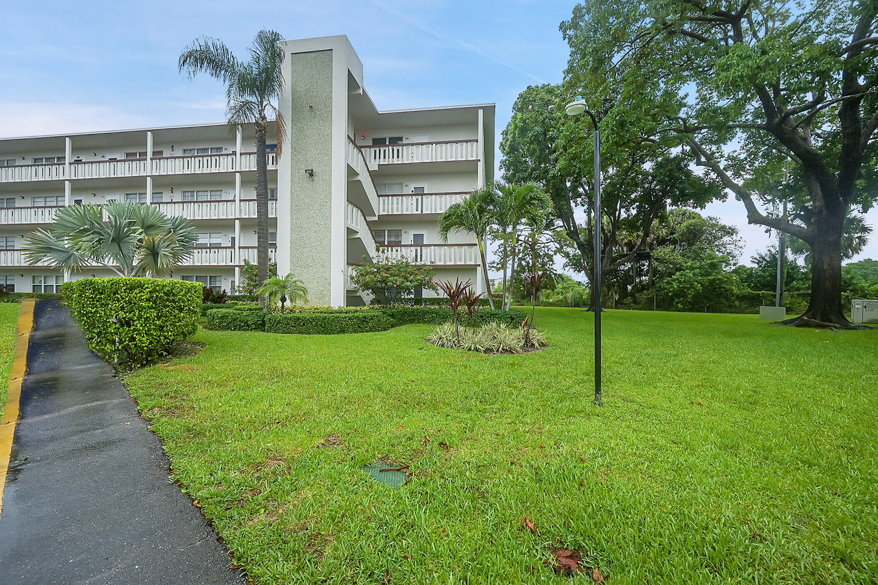 a view of a garden with a building in the background