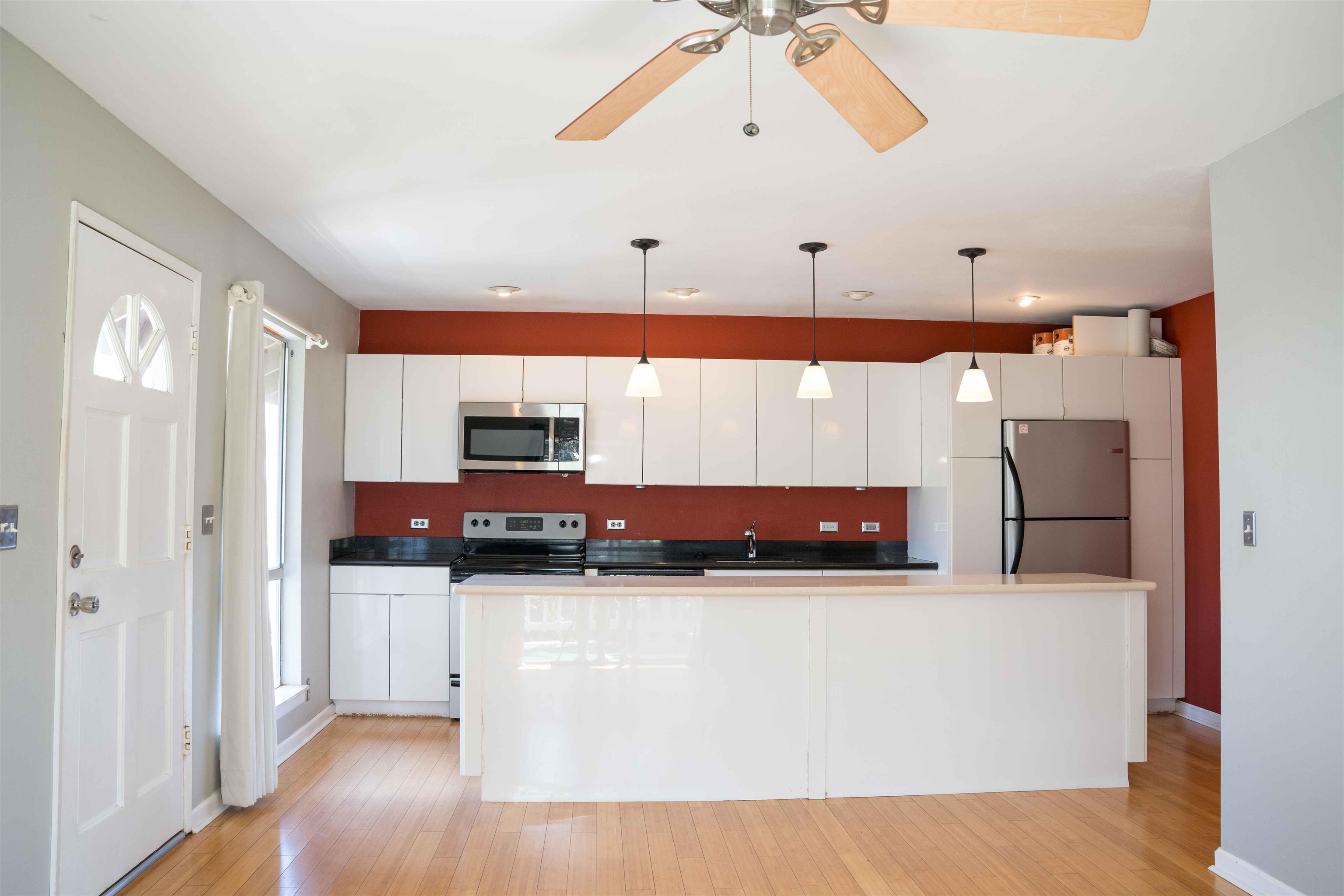 a view of a kitchen with a sink and a refrigerator