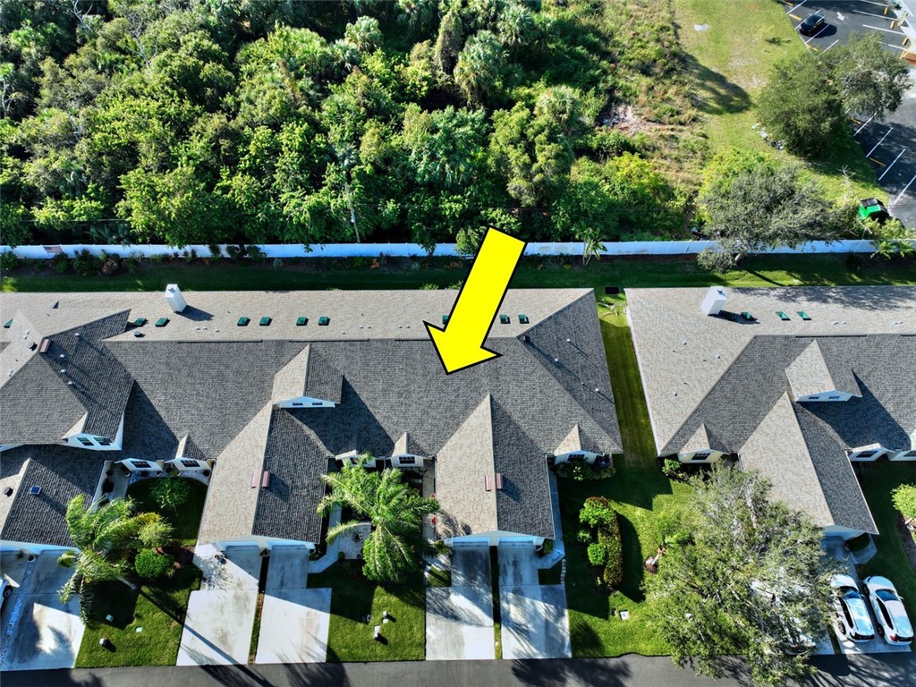 an aerial view of a house with swimming pool and garden view