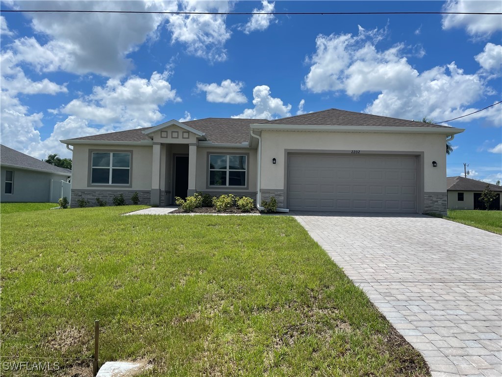 a front view of house with yard and outdoor seating