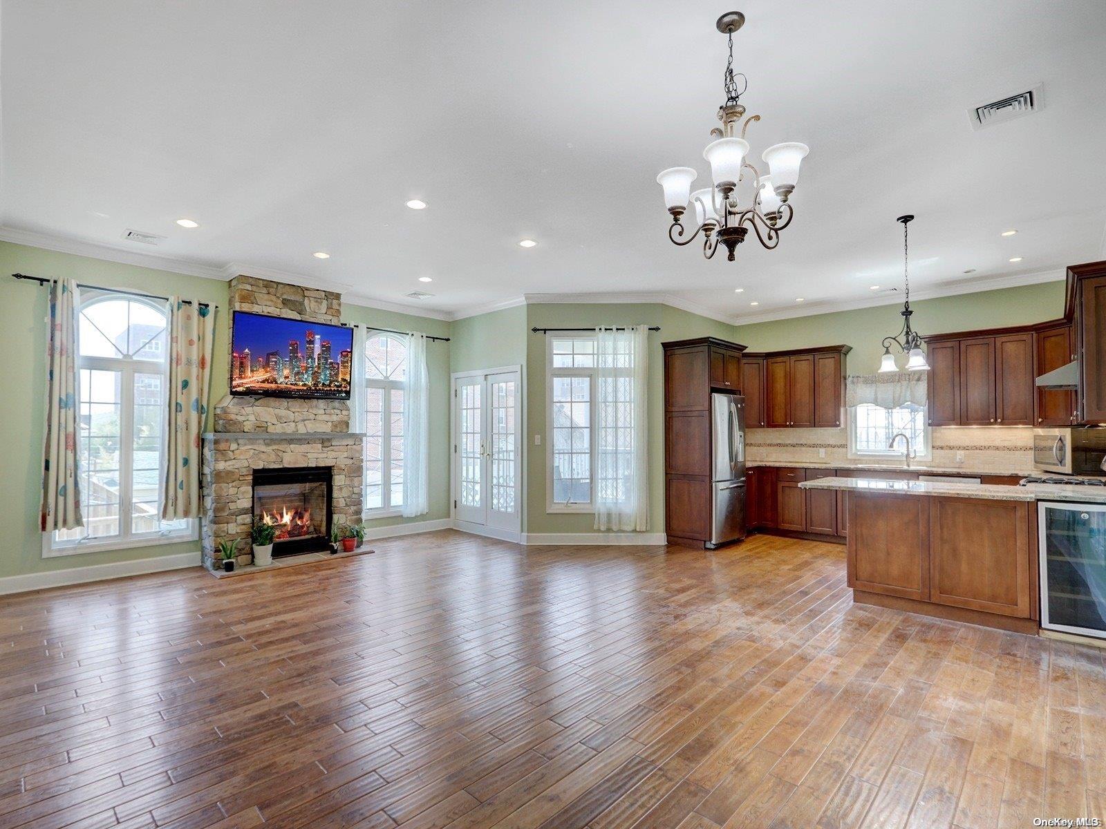 a view of a kitchen with a fireplace wooden floor and windows