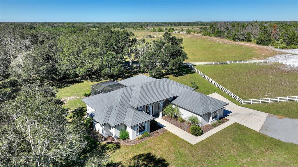 an aerial view of a house with ocean view