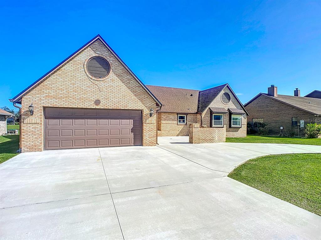 a view of house with outdoor space and parking