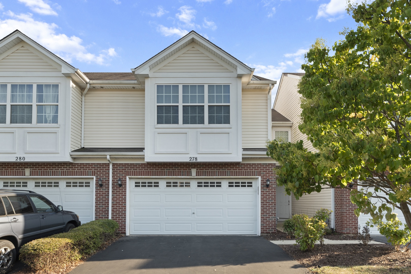 a front view of a house with a yard and garage