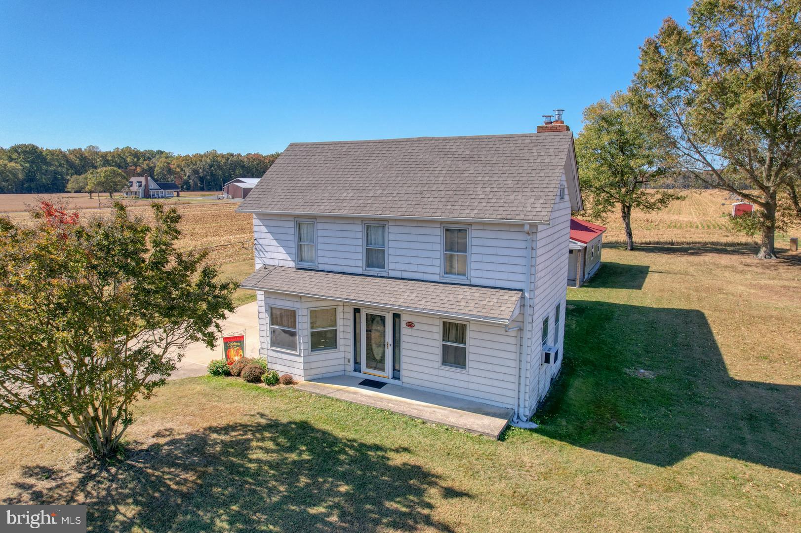 a view of a house with a yard and tree s