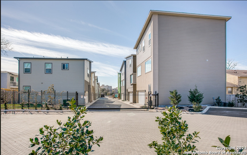 a front view of a house with a yard and outdoor seating