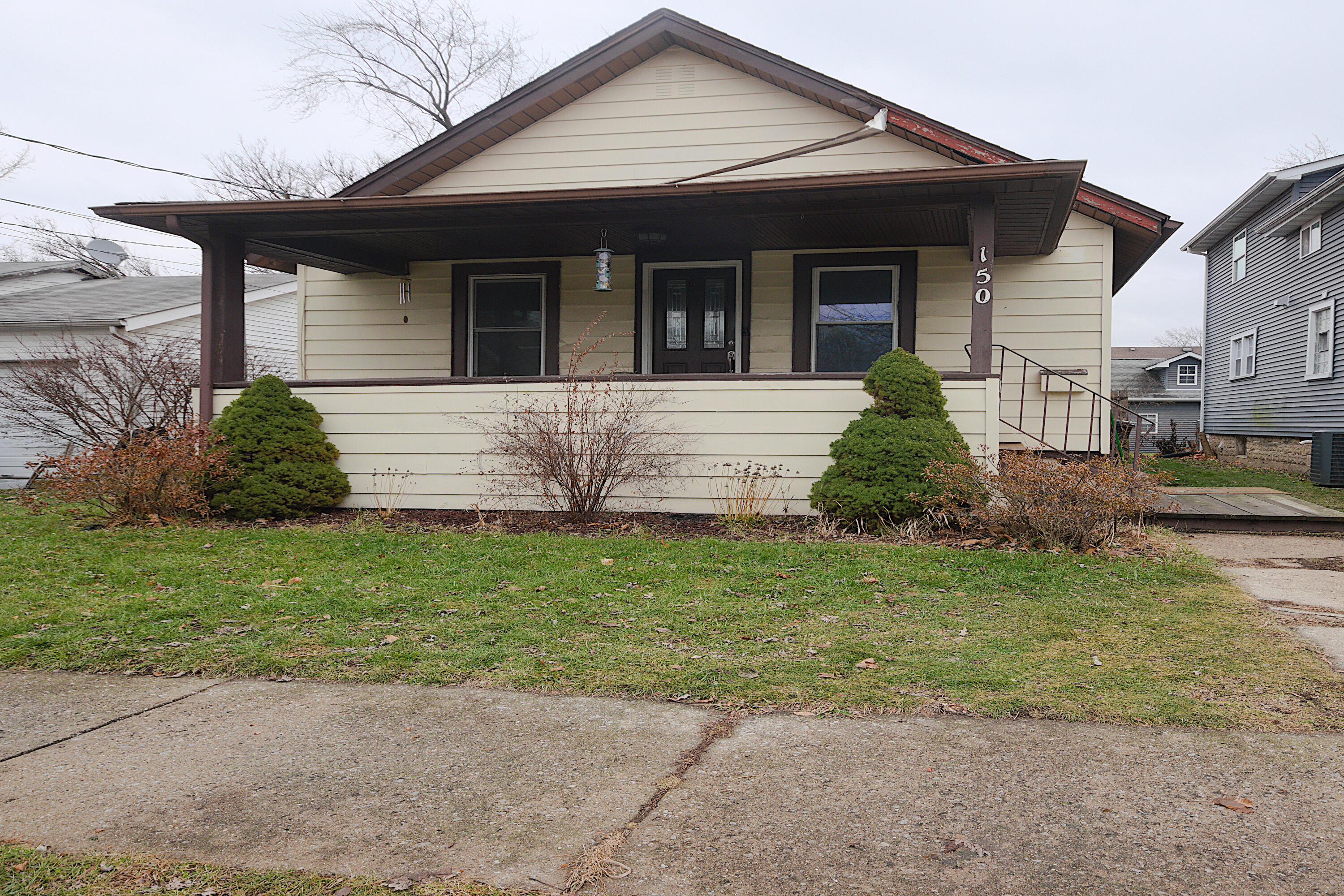 a front view of a house with a garden