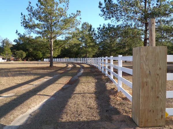 a view of a pathway with a wrought fence