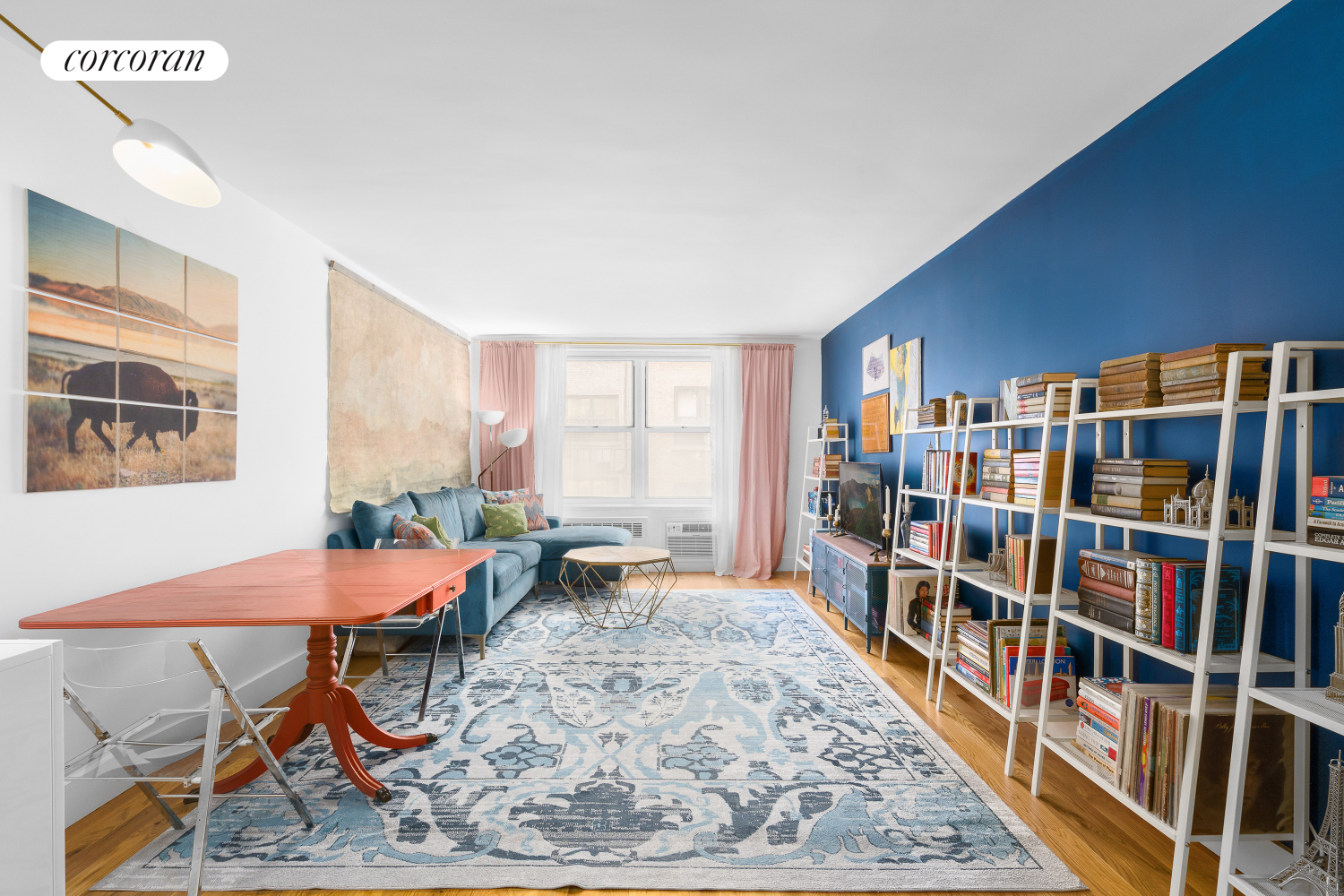 a living room with lots of furniture and a book shelf