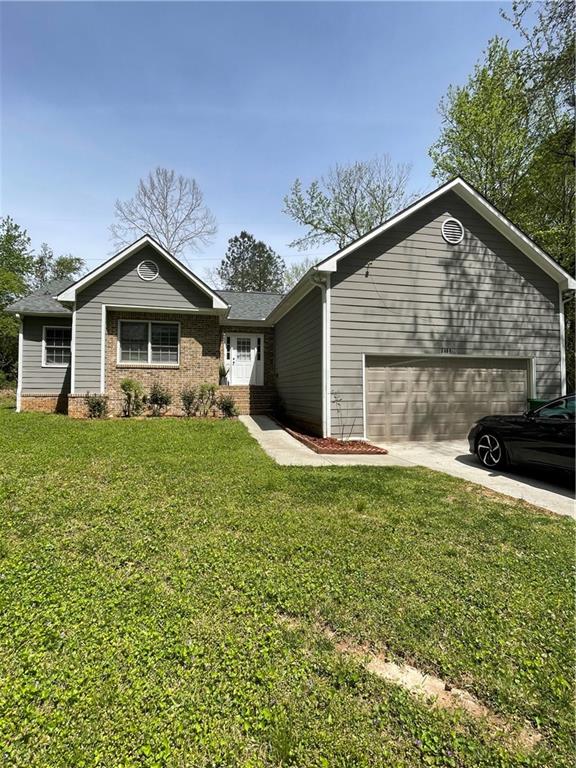 a front view of a house with a garden and yard