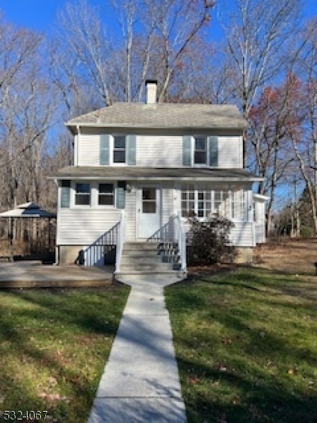 a front view of a house with a yard table and chairs