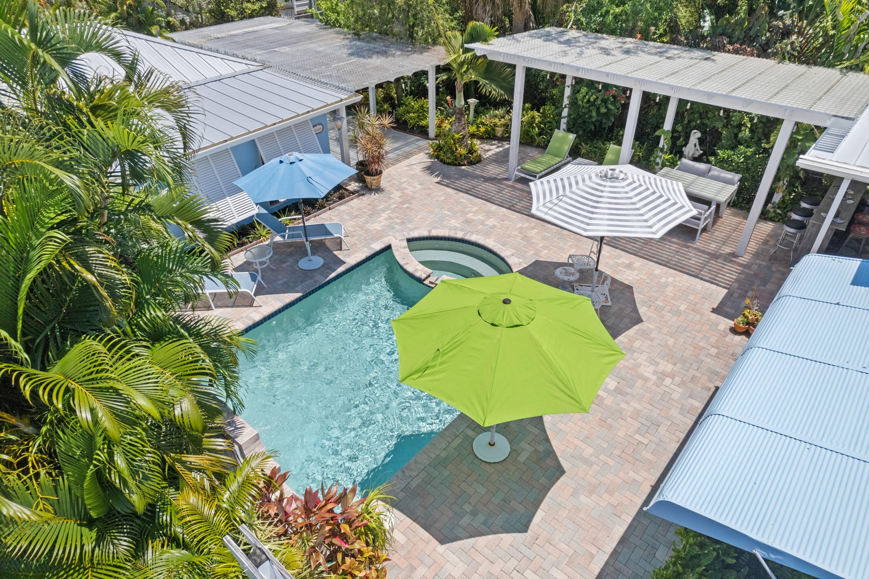 an aerial view of a house with backyard outdoor seating and green space