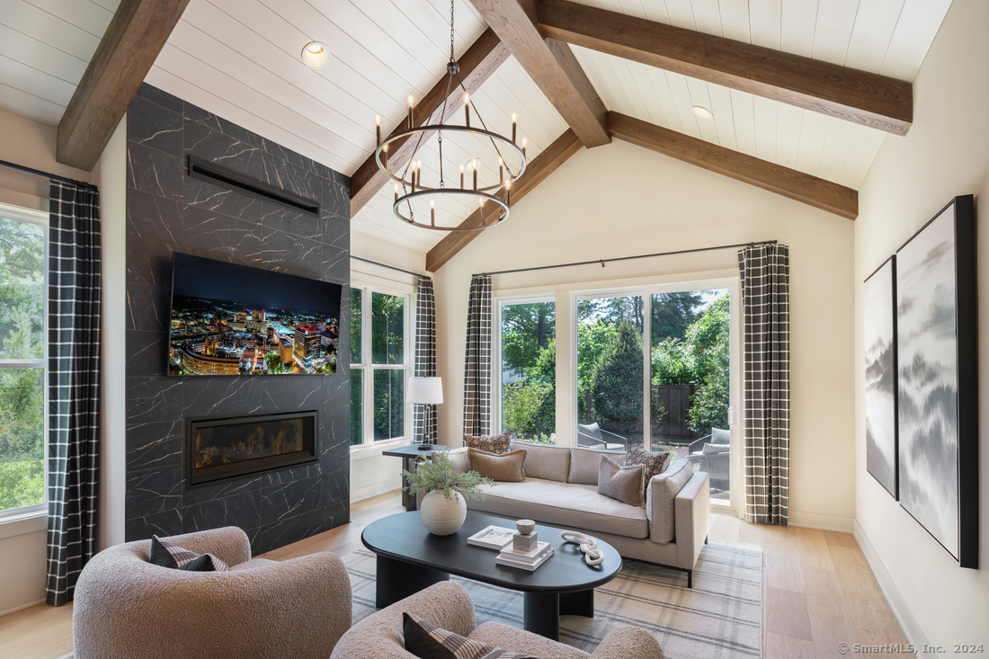 a living room with furniture a fireplace and a flat screen tv