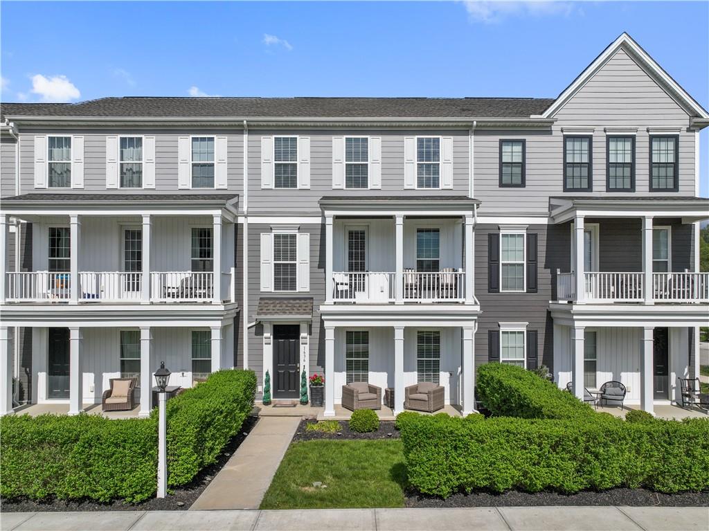 a front view of a residential apartment building with a yard