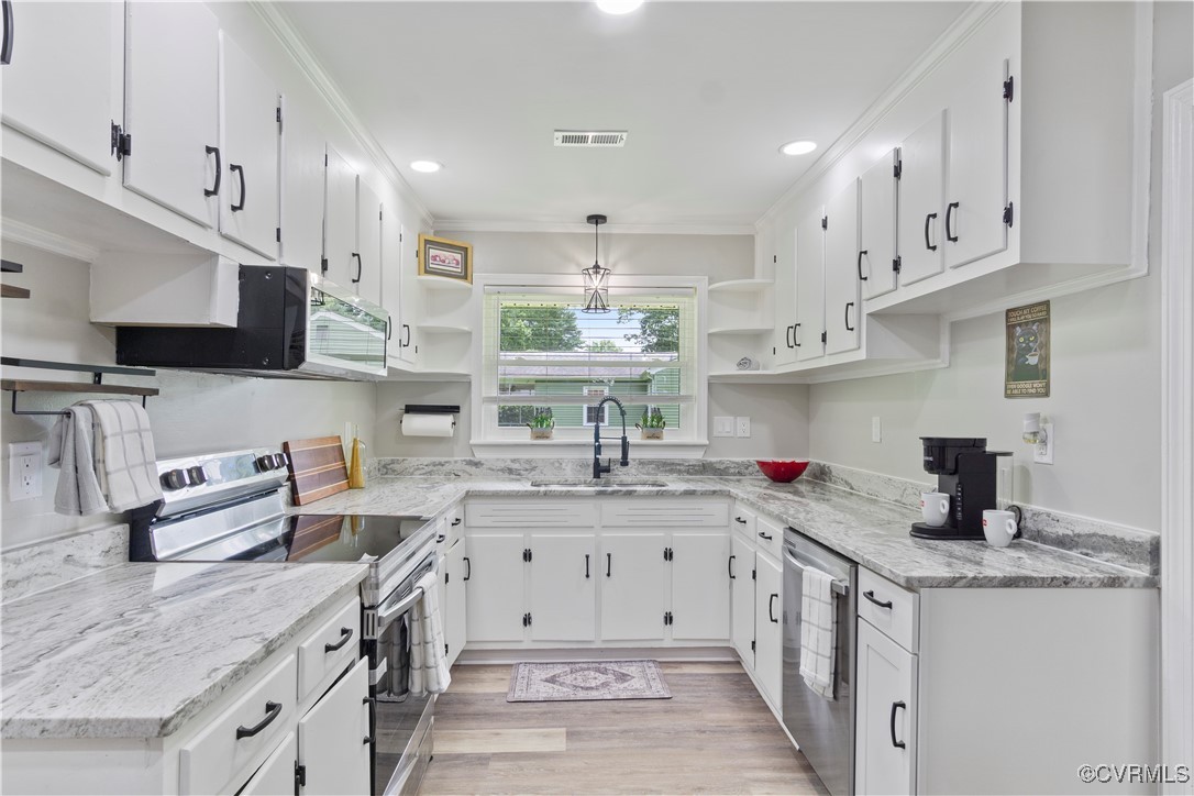 a kitchen with stainless steel appliances granite countertop a sink stove and cabinets