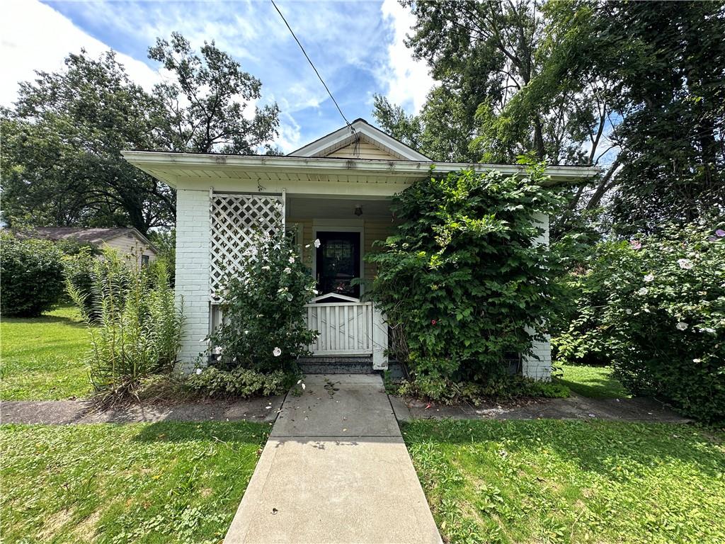 a front view of a house with garden