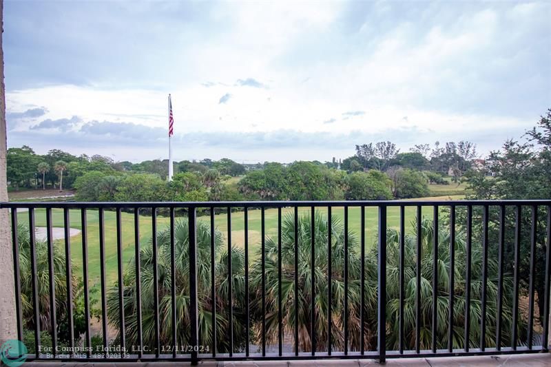 a view of a balcony with wooden fence