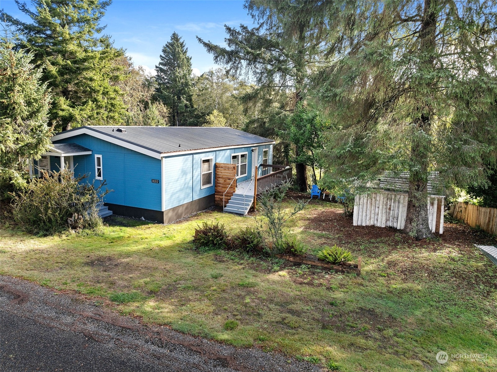 a view of a house with a yard and tree s