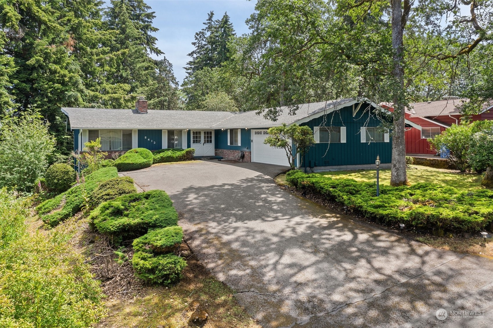 a front view of a house with a yard and shrubs