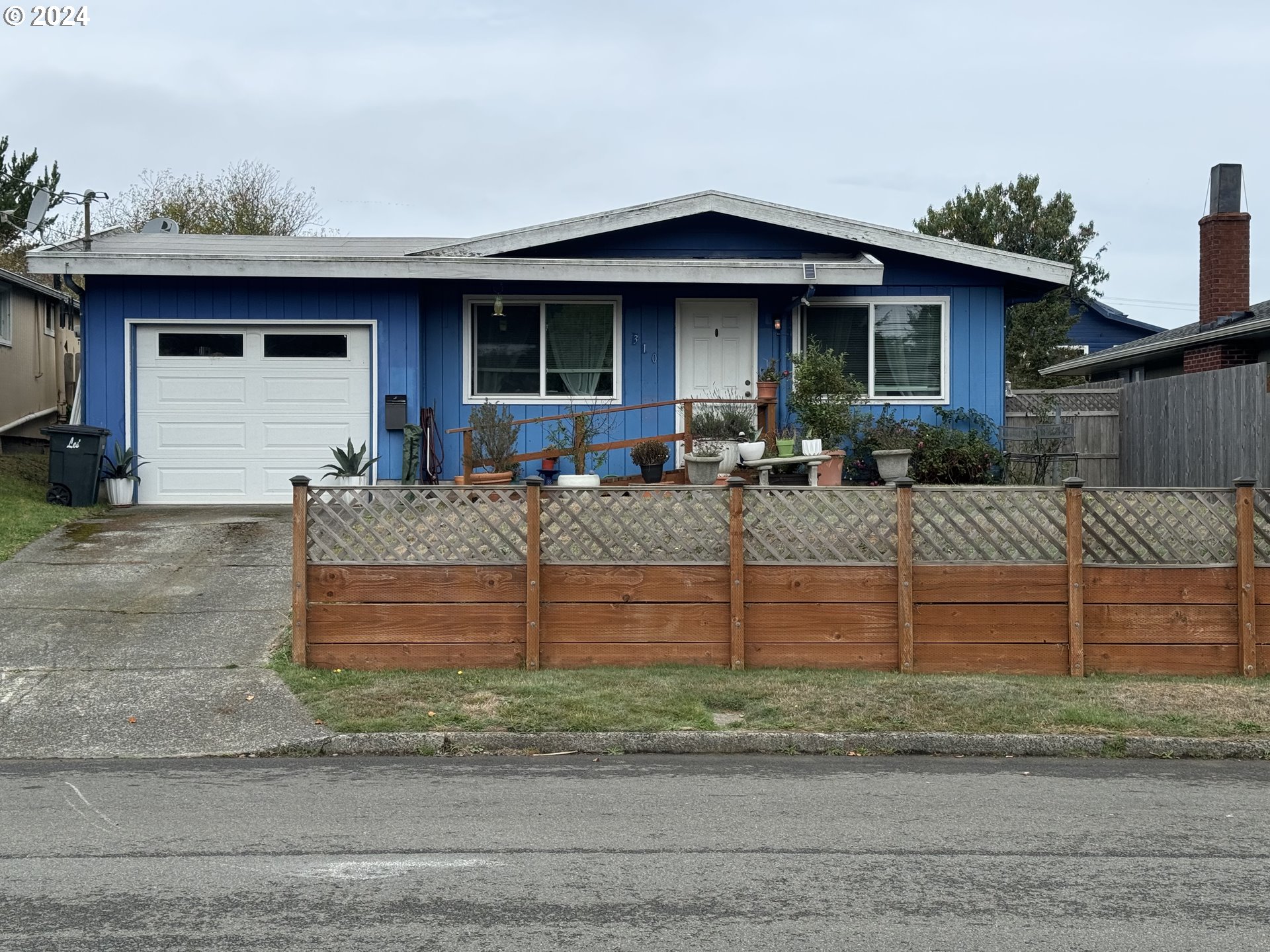 a front view of house with car parked