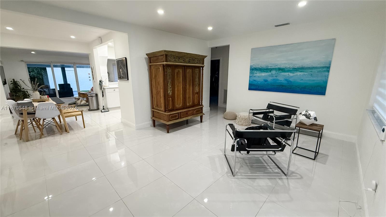 a living room with furniture a air conditioner vent and a window