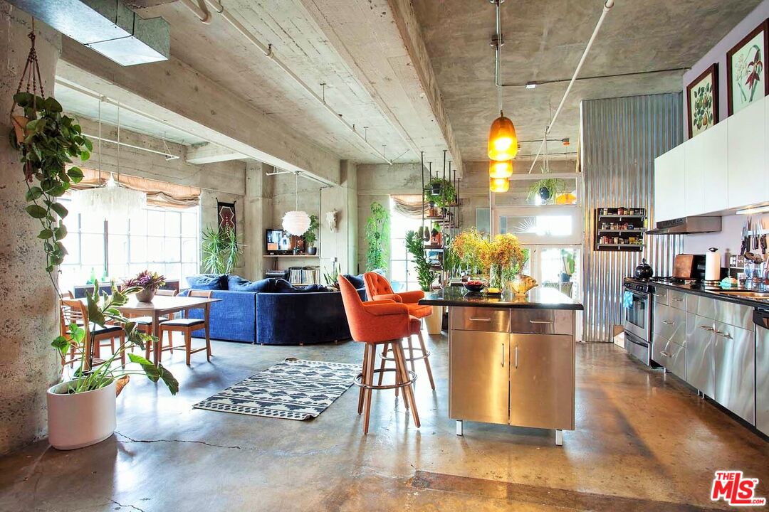 a view of a dining room with furniture a chandelier and wooden floor