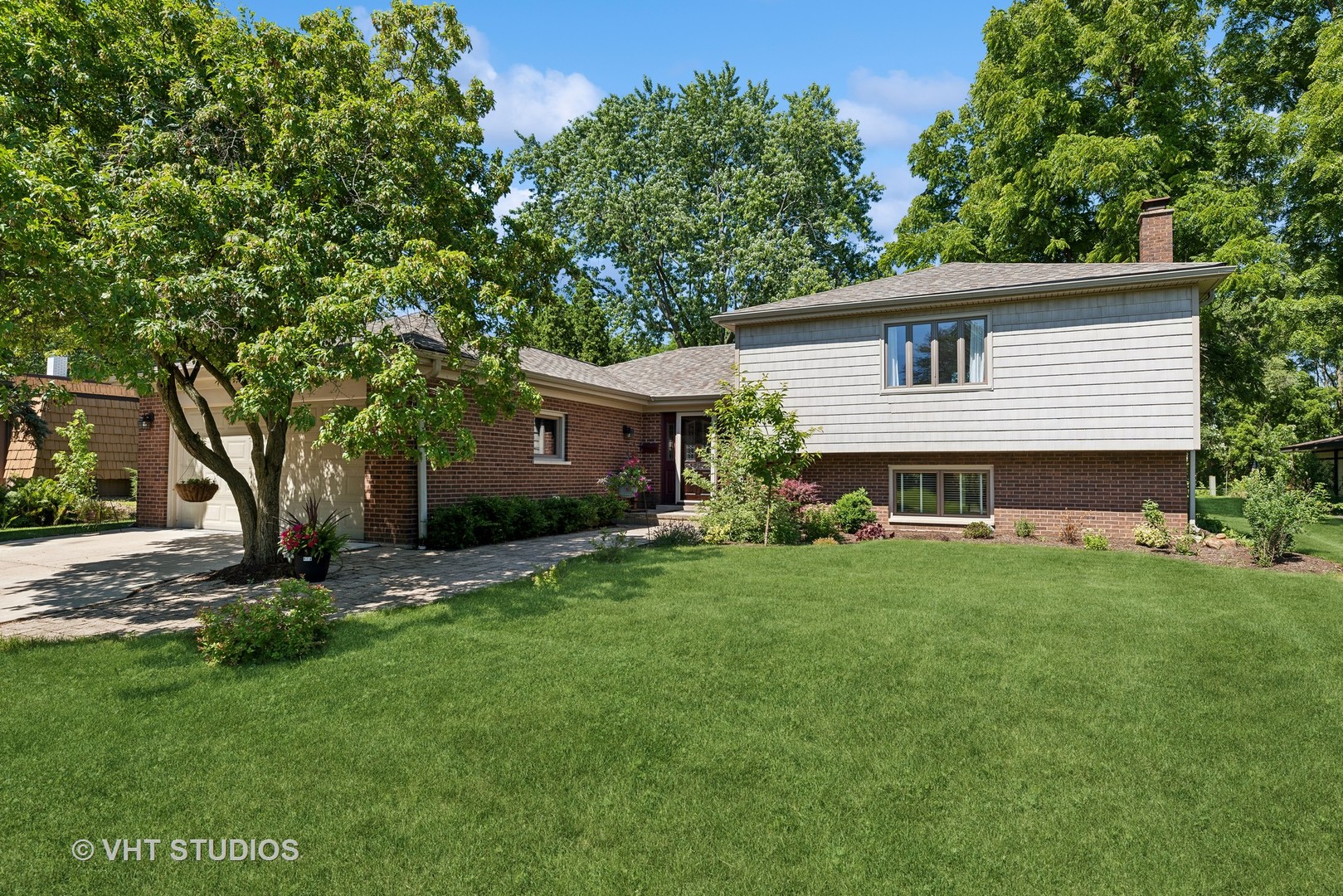 a front view of house with yard and green space