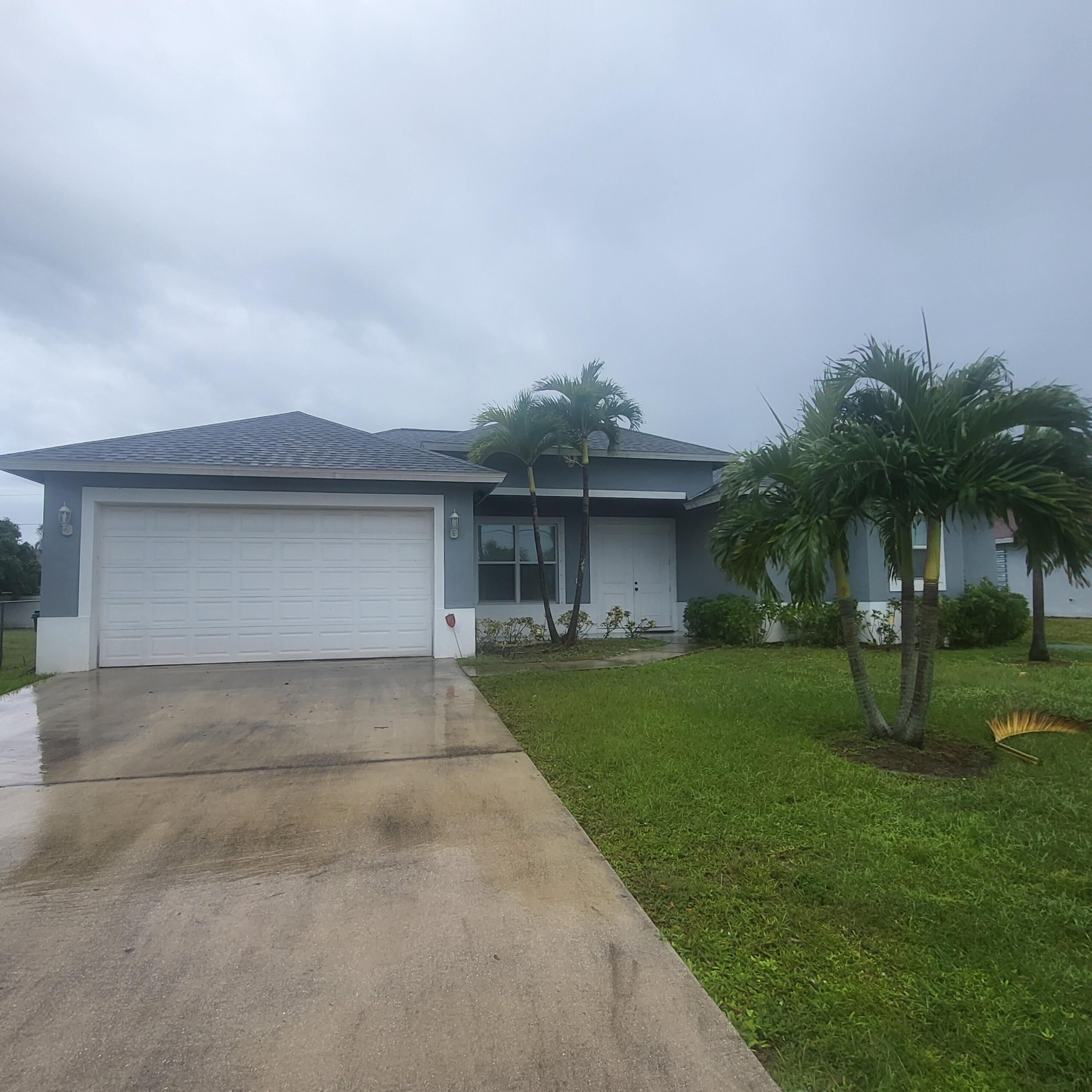 a front view of house with a garden and patio