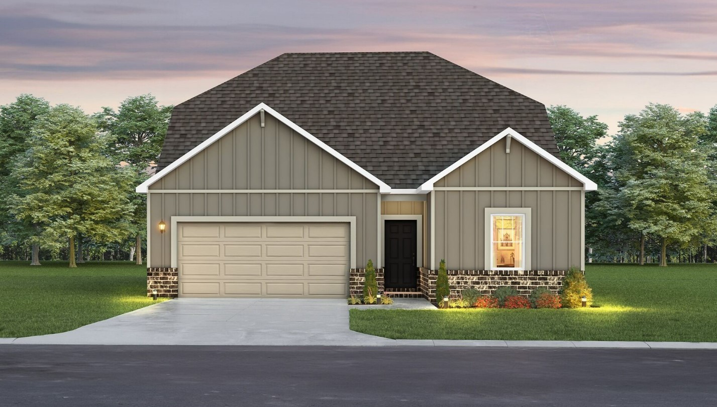 a front view of house with garage and green space