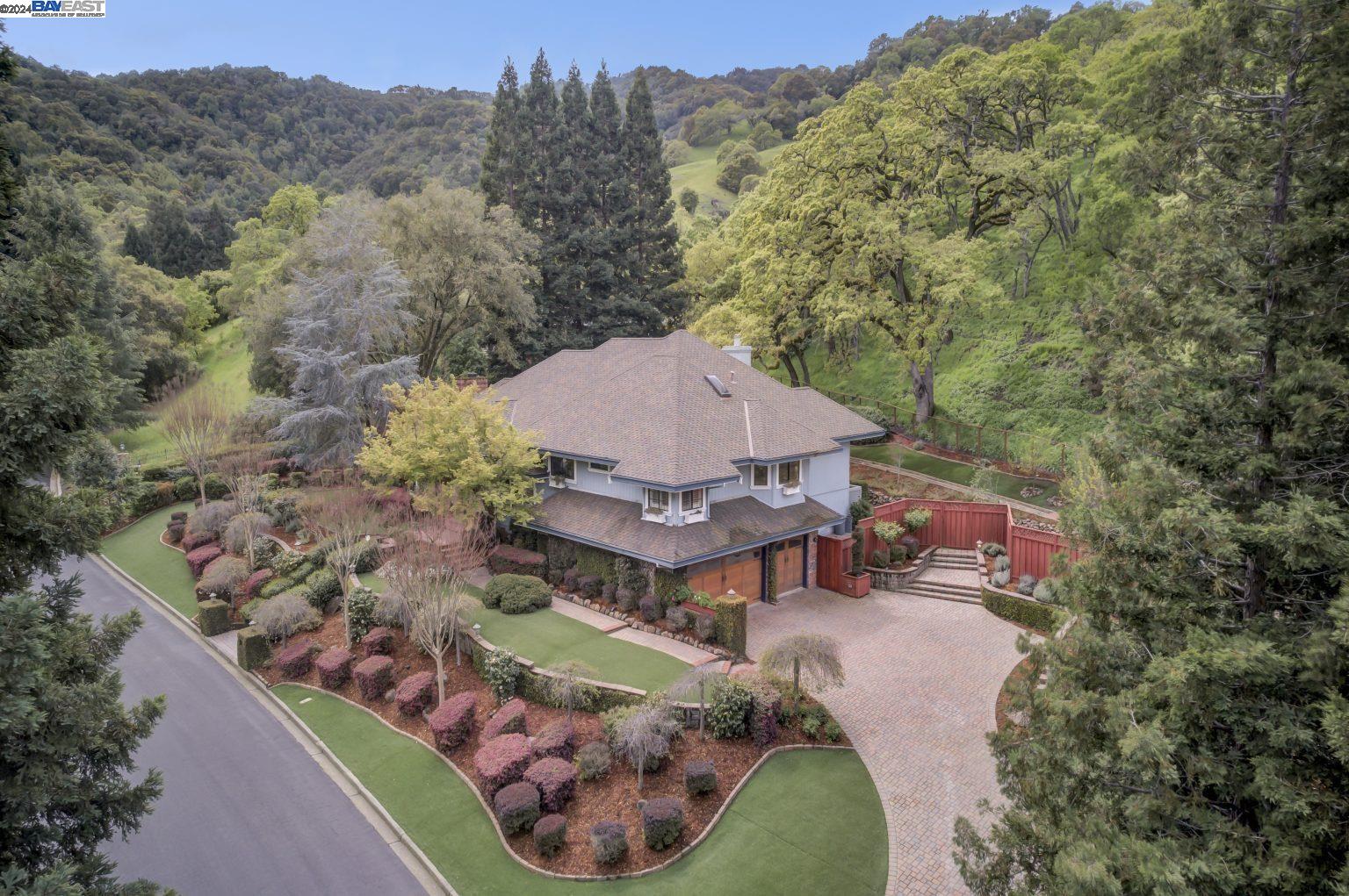 an aerial view of a house around a garden