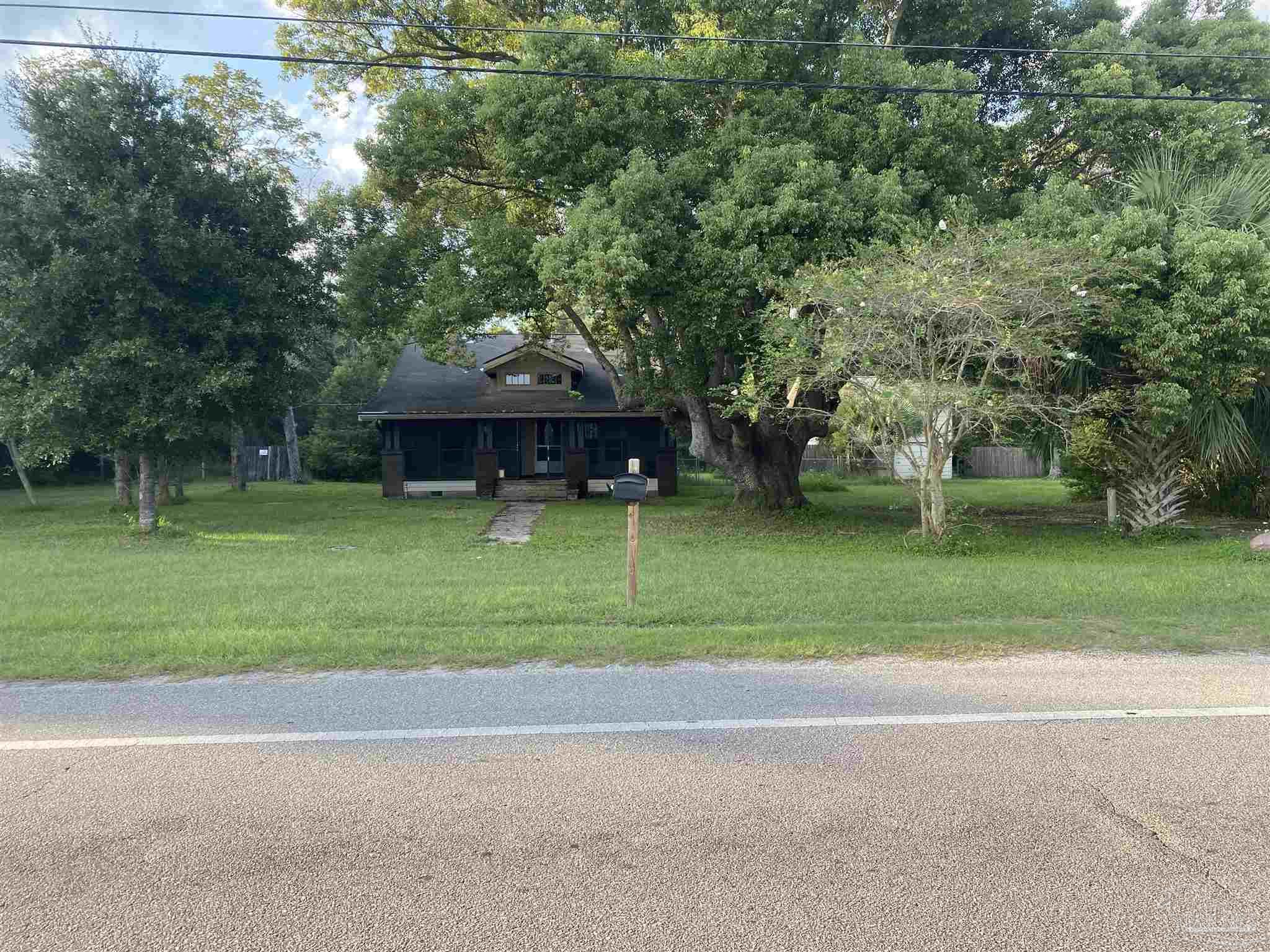 a view of a house with a yard and sitting area