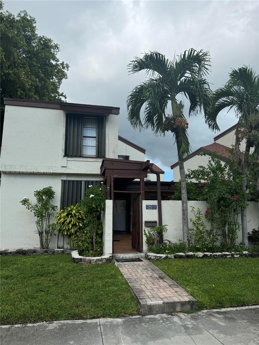 a front view of a house with a garden and a yard