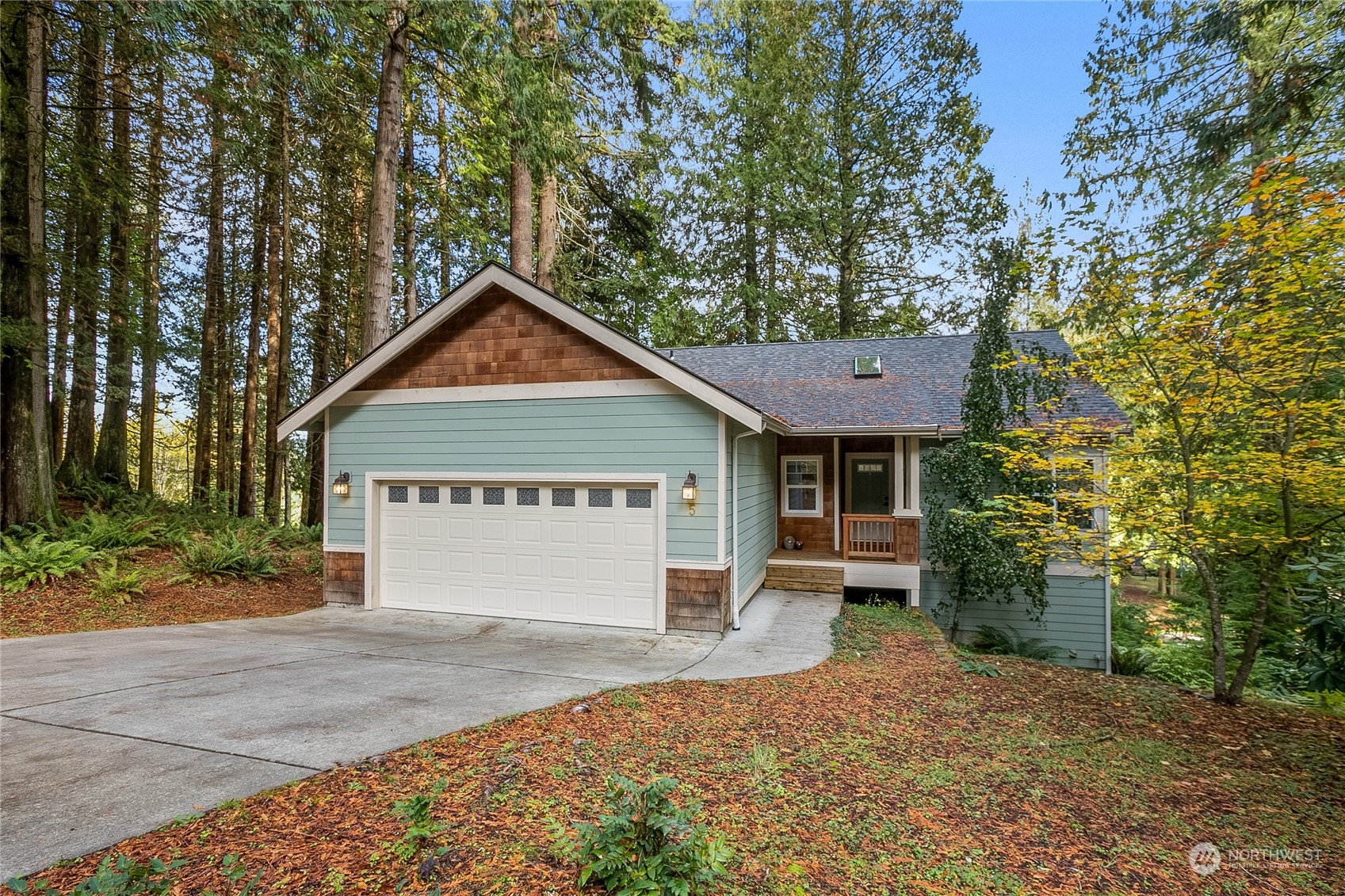 a view of a house with a yard and garage