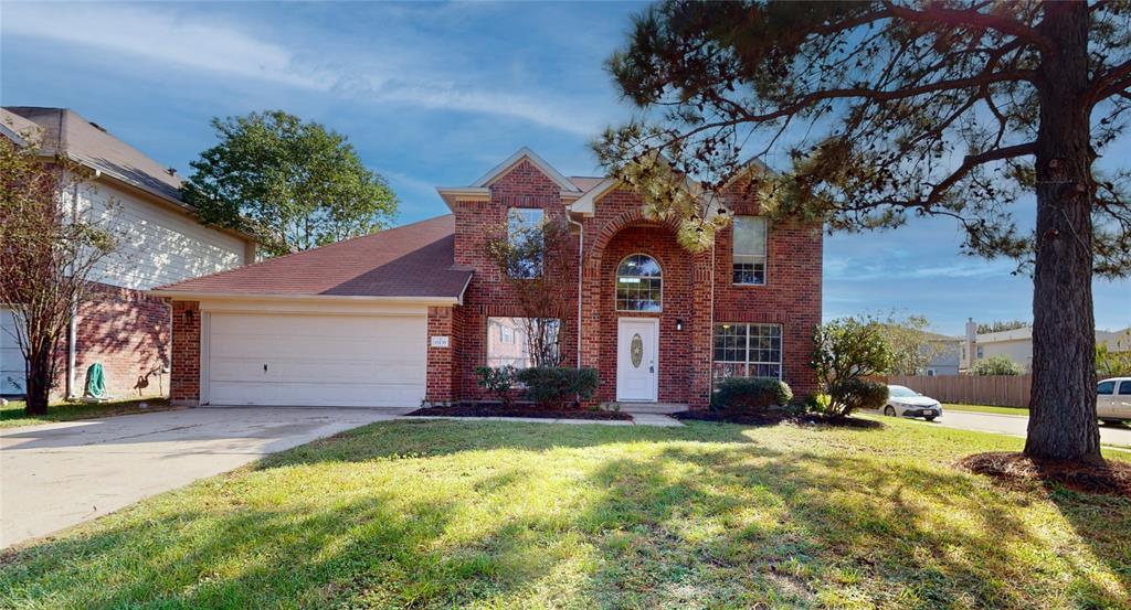 a front view of a house with a yard and garage