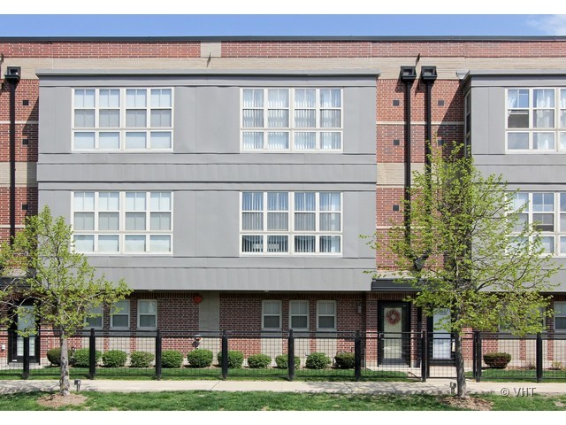 a view of a brick building next to a yard