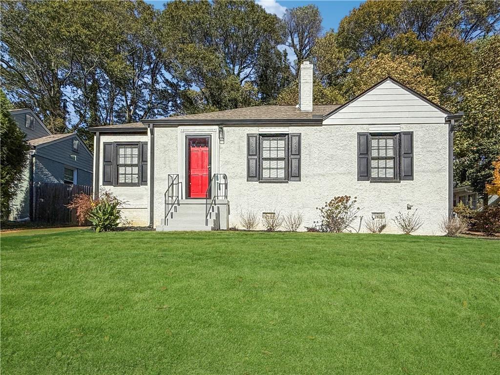 a front view of house with yard and green space