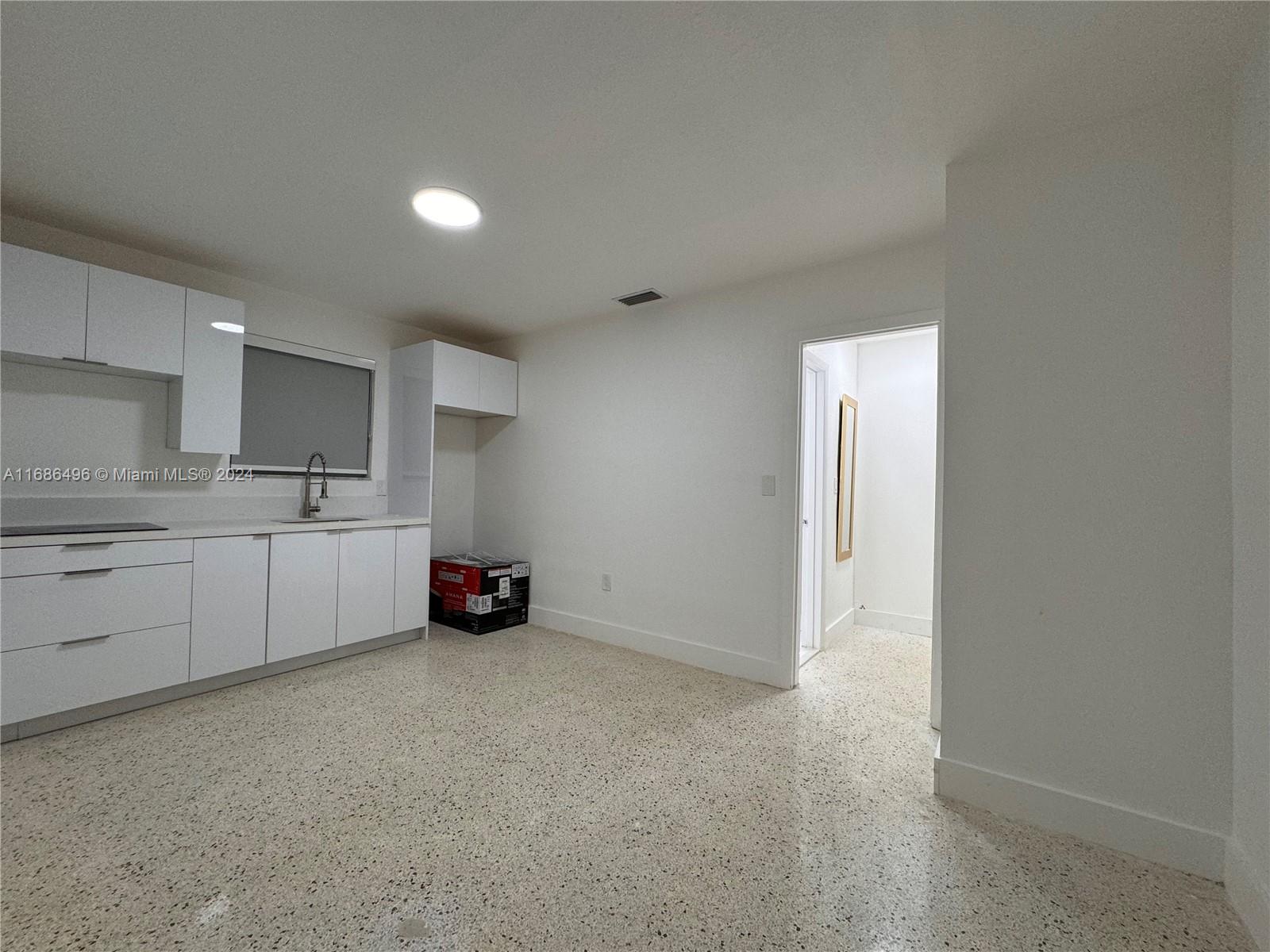 a kitchen with stainless steel appliances a sink cabinets and a refrigerator