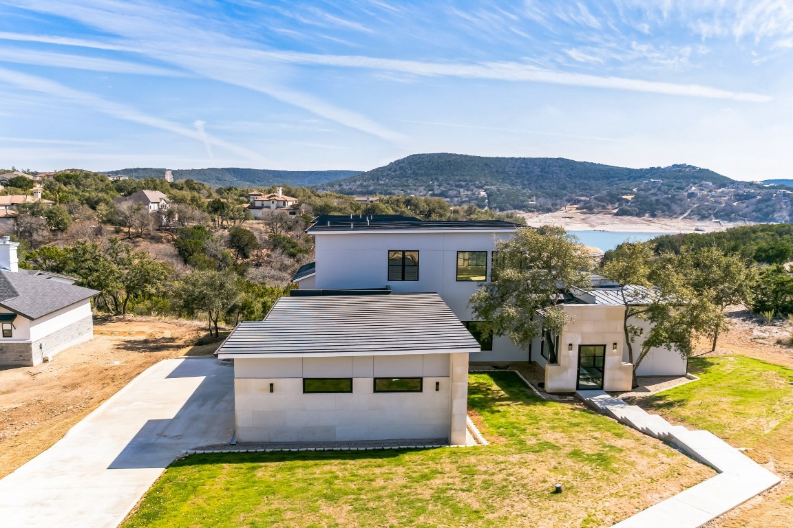 an aerial view of a house with a yard