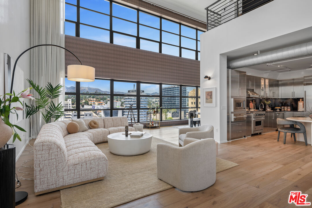 a living room with furniture and a floor to ceiling window