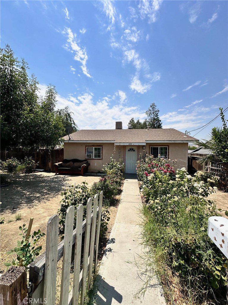 a front view of house with yard outdoor seating and barbeque oven